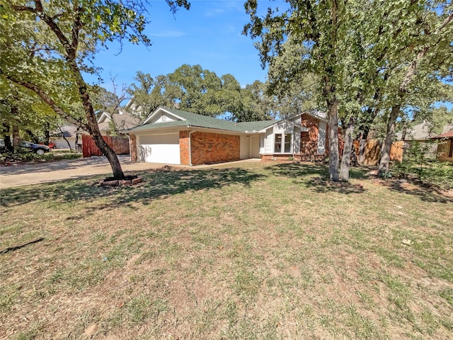 ranch-style home featuring a front lawn and a garage