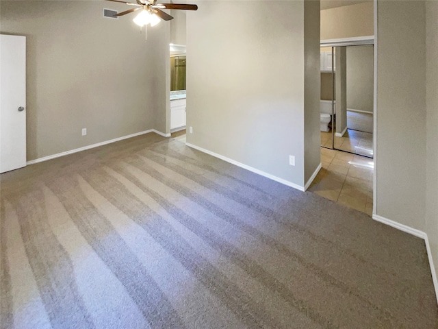 carpeted empty room featuring ceiling fan