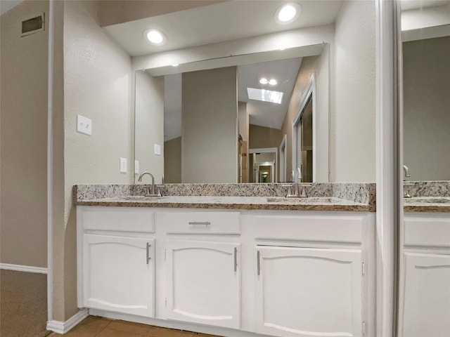 bathroom with tile patterned flooring and vanity