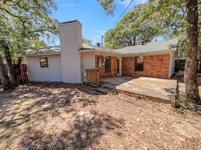 rear view of property featuring a patio and a deck