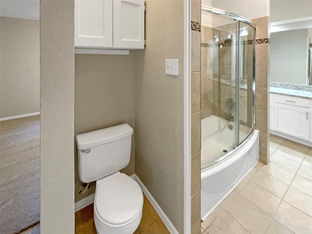 409 Misty Oaks St, Azle, TX 76020 - full bathroom featuring shower / bath combination with glass door, toilet, vanity, tile patterned floors, and baseboards