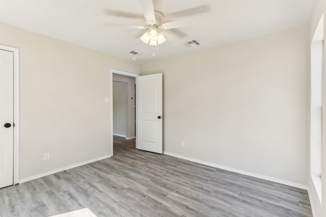 spare room featuring light wood-type flooring and ceiling fan