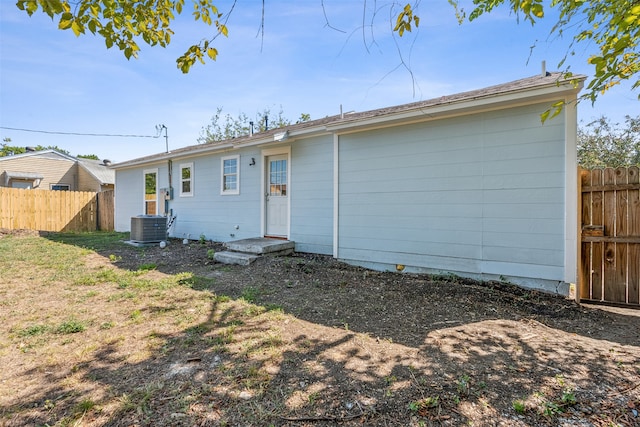 rear view of house featuring central AC unit