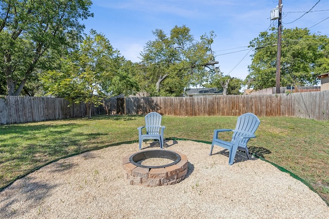 view of yard with a fire pit