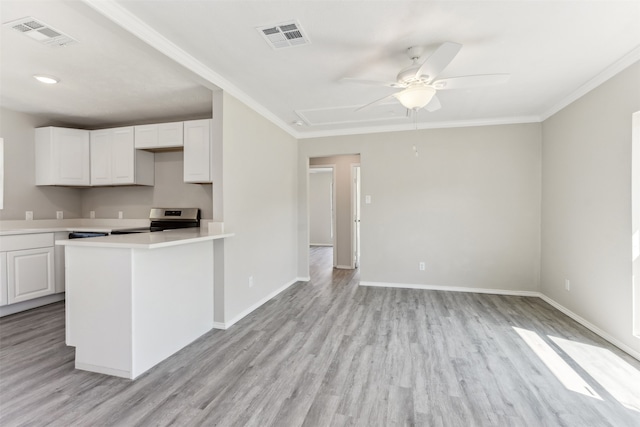 kitchen with white cabinets, light hardwood / wood-style flooring, and stainless steel range oven