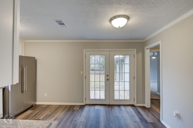 doorway to outside with light wood-type flooring, french doors, ornamental molding, and a textured ceiling