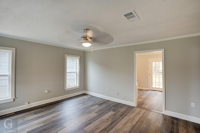 empty room with dark wood-type flooring, ceiling fan, a healthy amount of sunlight, and crown molding