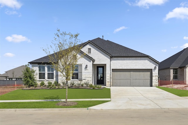 view of front of property with a front lawn and a garage