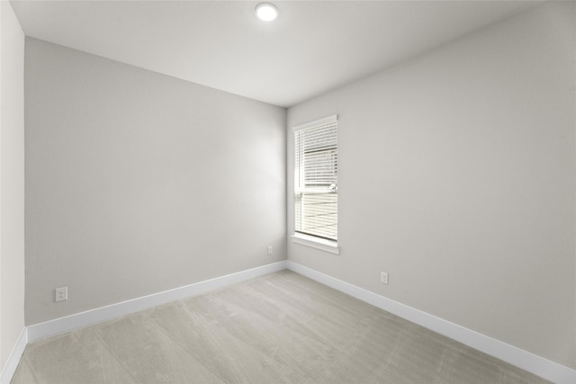 unfurnished room with light colored carpet