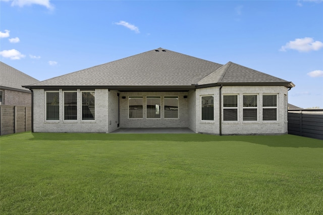 rear view of house featuring a patio and a yard