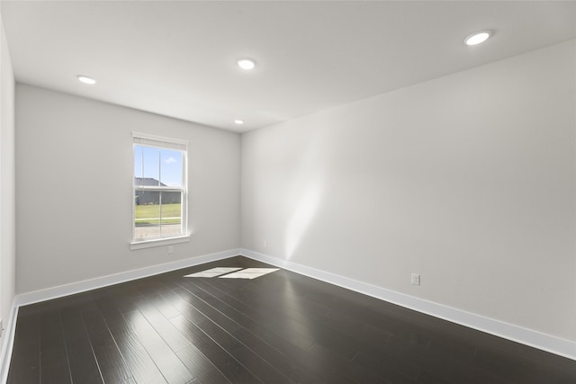 unfurnished room featuring dark hardwood / wood-style flooring