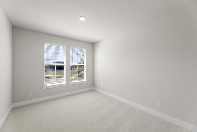 spare room featuring light colored carpet