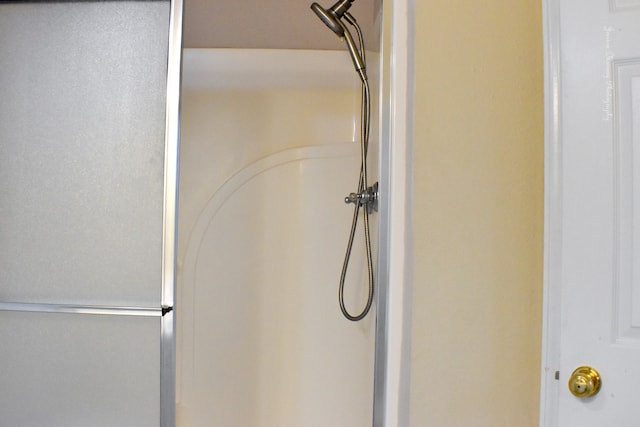 laundry room featuring hookup for an electric dryer, light tile patterned floors, washer hookup, and cabinets