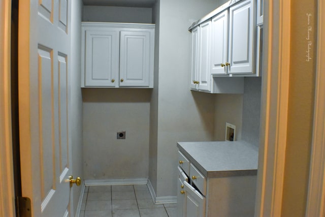 clothes washing area with cabinets and hookup for a washing machine