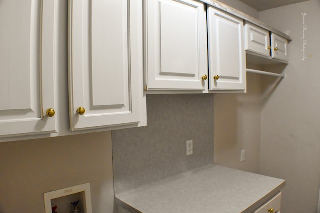 washroom with cabinets, hookup for an electric dryer, light tile patterned flooring, and hookup for a washing machine