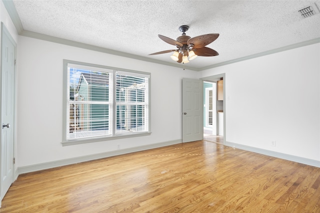 unfurnished room featuring a textured ceiling, light hardwood / wood-style floors, ornamental molding, and ceiling fan