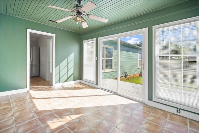 entryway featuring wood ceiling, light tile patterned flooring, and ceiling fan