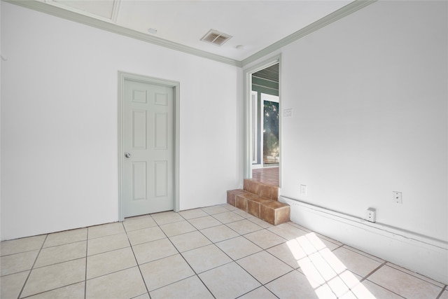 tiled spare room with ornamental molding