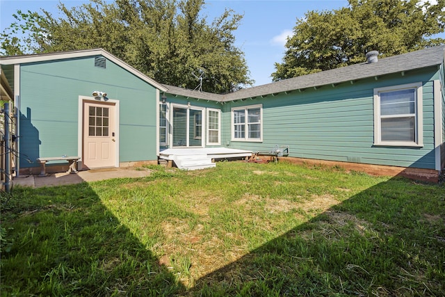 rear view of house with a yard