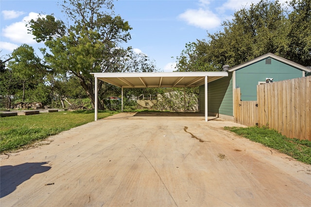 view of car parking with a carport and a yard