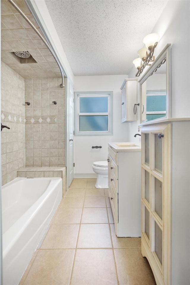 full bathroom featuring tiled shower / bath combo, vanity, toilet, and tile patterned floors