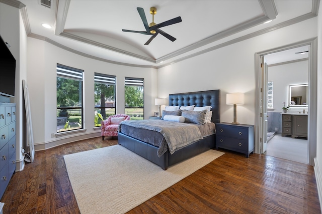 bedroom with dark hardwood / wood-style flooring, crown molding, a tray ceiling, ceiling fan, and ensuite bath