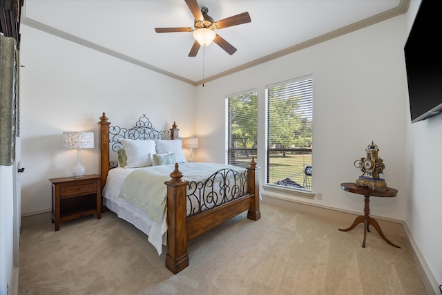 carpeted bedroom with ornamental molding and ceiling fan