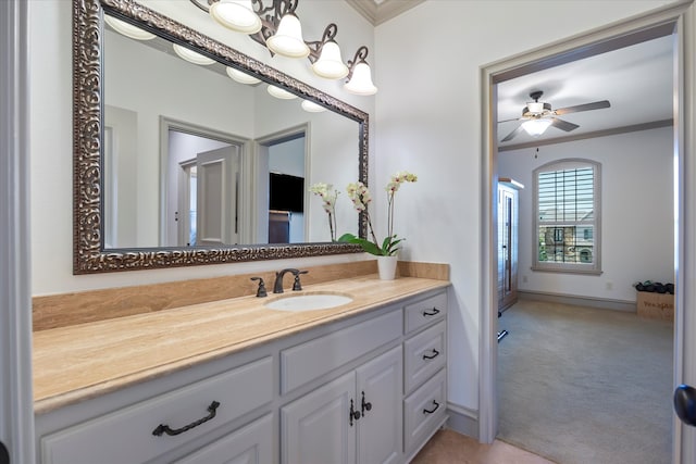 bathroom featuring ceiling fan, vanity, and ornamental molding