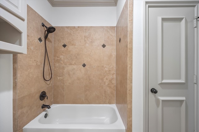 bathroom with ornamental molding and tiled shower / bath combo