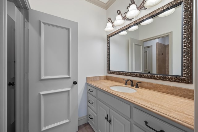 bathroom with ornamental molding and vanity