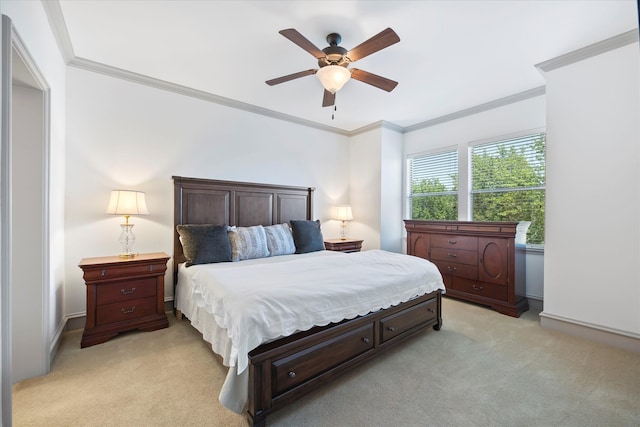 carpeted bedroom with ornamental molding and ceiling fan