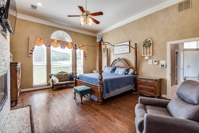 bedroom featuring ceiling fan, crown molding, dark hardwood / wood-style floors, and multiple windows