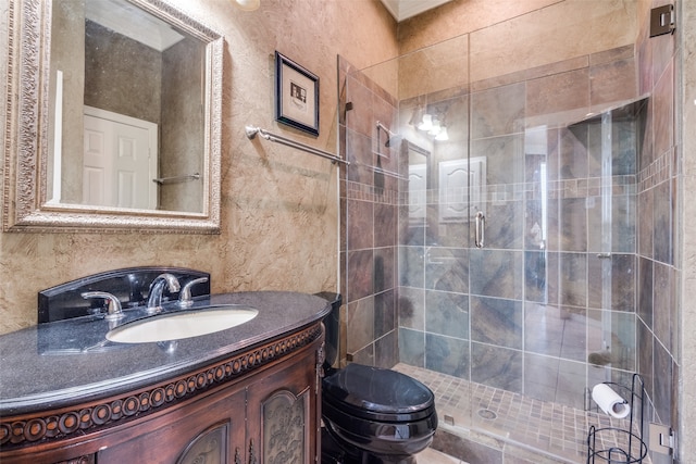 bathroom with vanity, a shower with shower door, and toilet