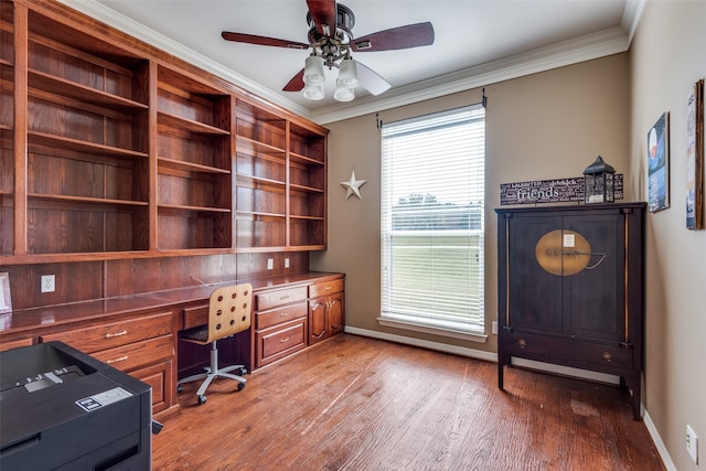 office with built in desk, ornamental molding, hardwood / wood-style floors, and ceiling fan