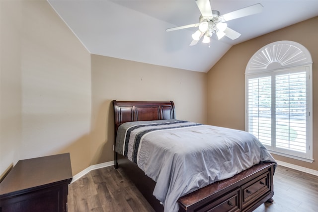 bedroom featuring ceiling fan, vaulted ceiling, and dark hardwood / wood-style flooring