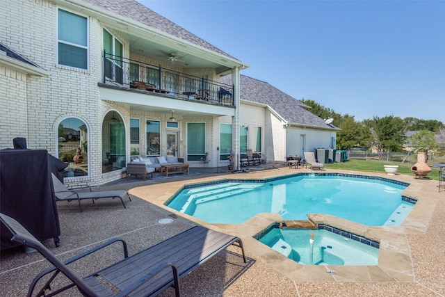 view of pool with a patio and an in ground hot tub