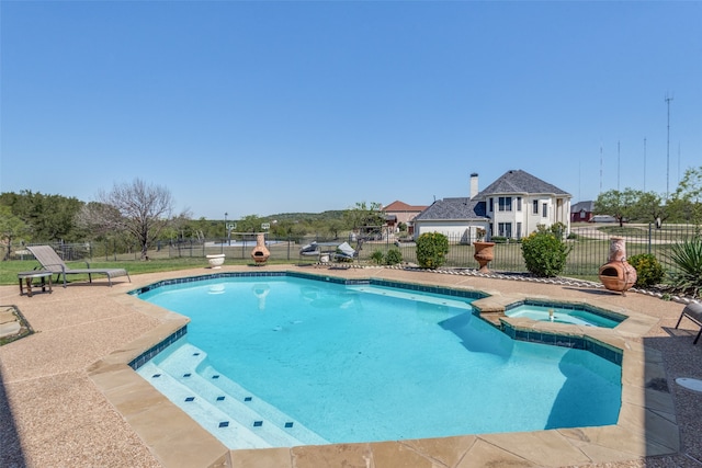 view of pool with an in ground hot tub