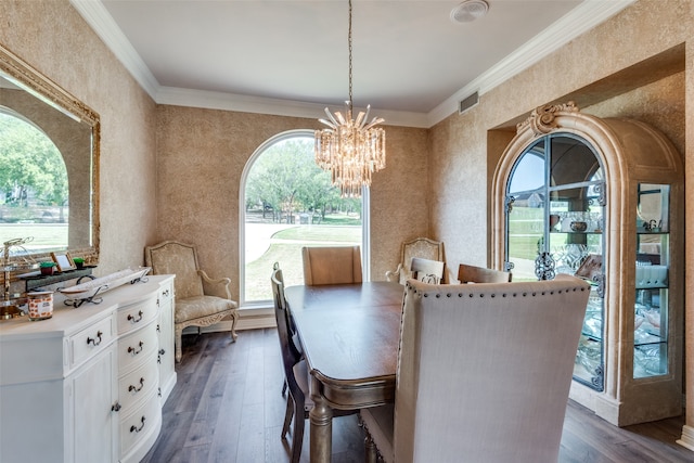 dining room featuring ornamental molding, dark hardwood / wood-style floors, and a chandelier