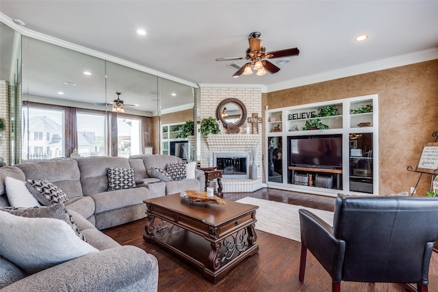 living room with ornamental molding, ceiling fan, a fireplace, and dark hardwood / wood-style flooring