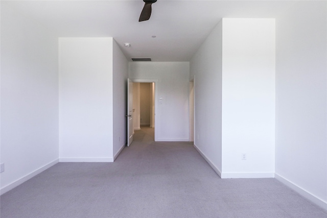 interior space with ceiling fan and light colored carpet