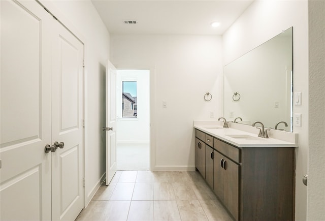 bathroom with tile patterned flooring and vanity