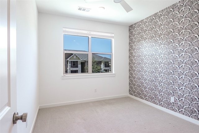 carpeted empty room featuring ceiling fan