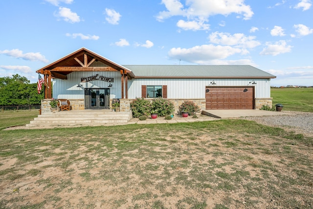 view of front of property with a garage and a front lawn