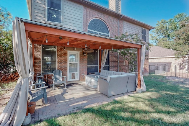 rear view of house with a yard, an outdoor hangout area, a patio, and ceiling fan