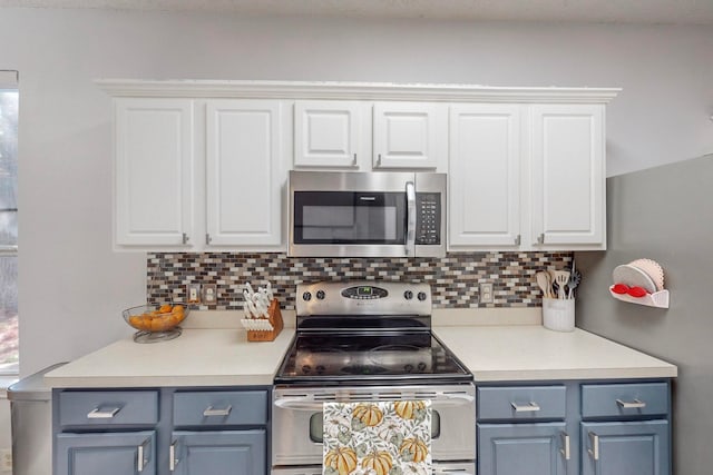 kitchen with white cabinetry, tasteful backsplash, stainless steel appliances, and blue cabinets