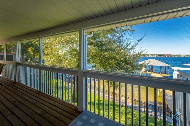 unfurnished sunroom with a water view