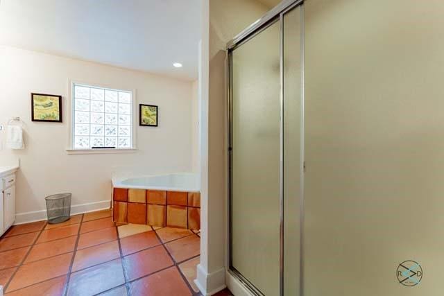 bathroom with shower with separate bathtub, tile patterned floors, and vanity