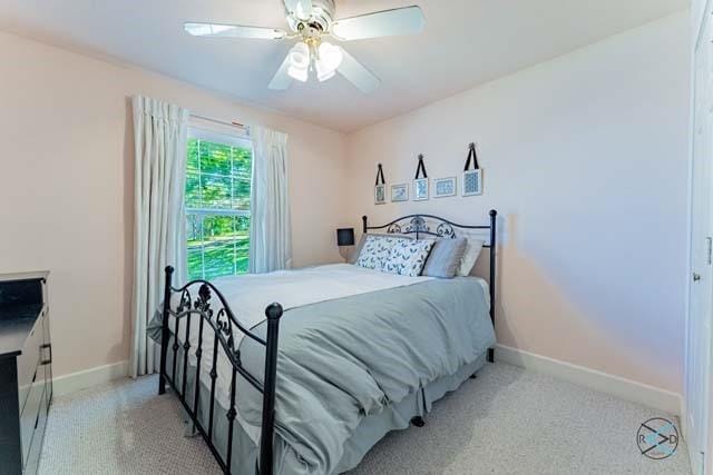 bedroom with light colored carpet and ceiling fan