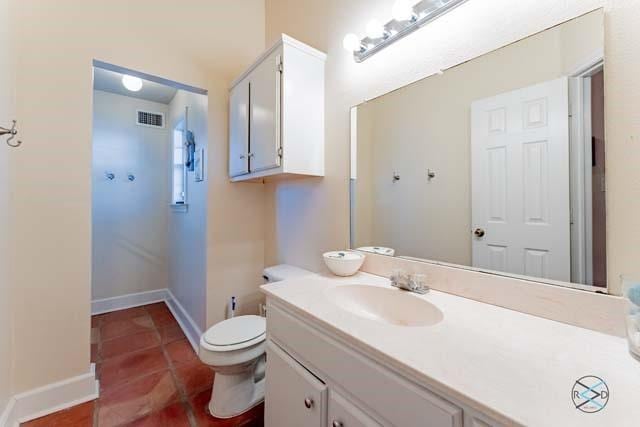 bathroom featuring vanity and toilet