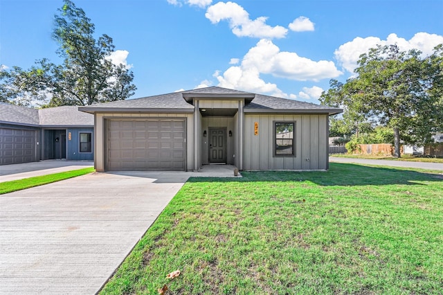 view of front facade with a garage and a front lawn